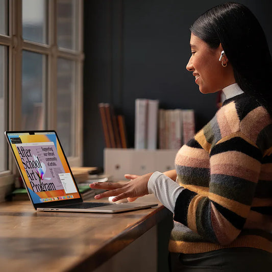 Student using a certified refurbished iPhone at a desk with a laptop