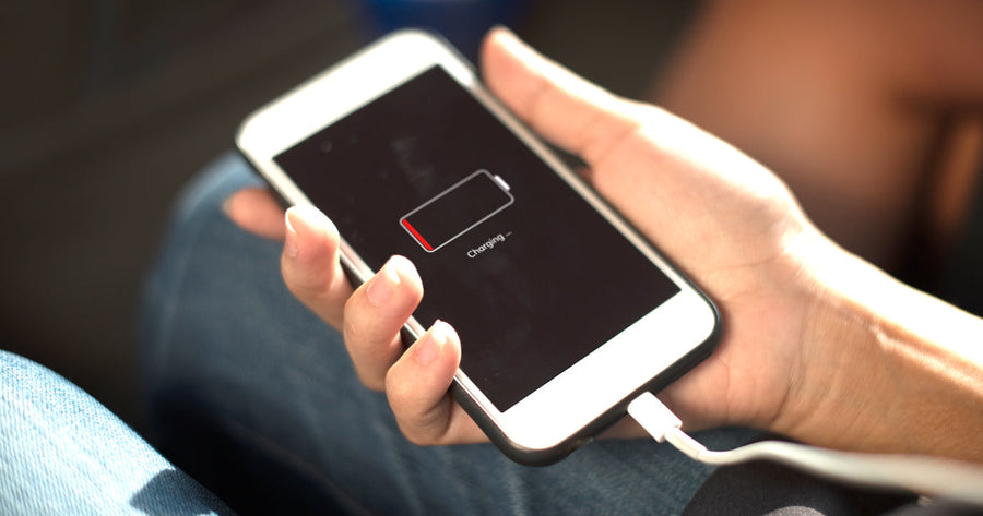 Technician checking battery health on a refurbished smartphone
