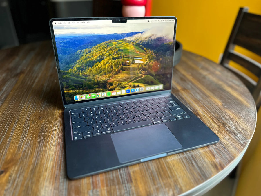 Certified refurbished MacBook Air M2 on a wooden desk